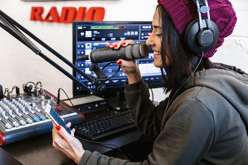 Female Radio Host with iPhone